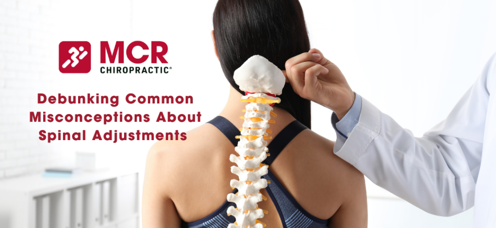 An image of a woman sitting in a chiropractors office with a model of the spine.
