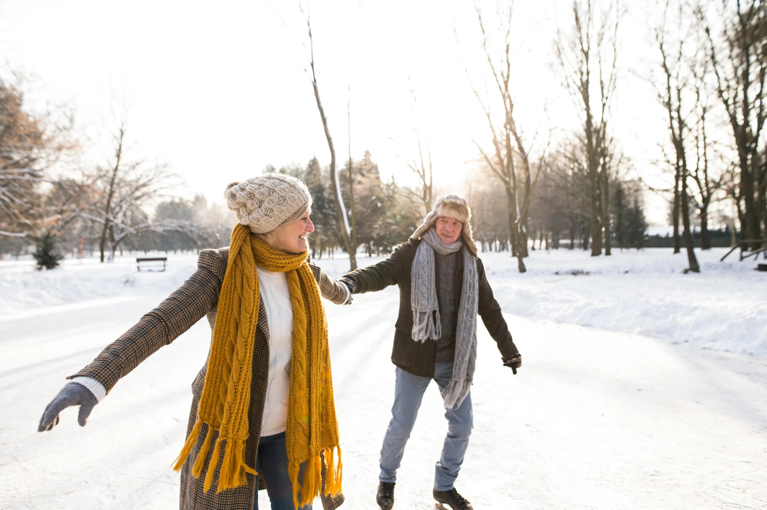 Two people ice skate on a snowy day embodying the spirit of wellness and activity promoted by MCR Chiropractic.