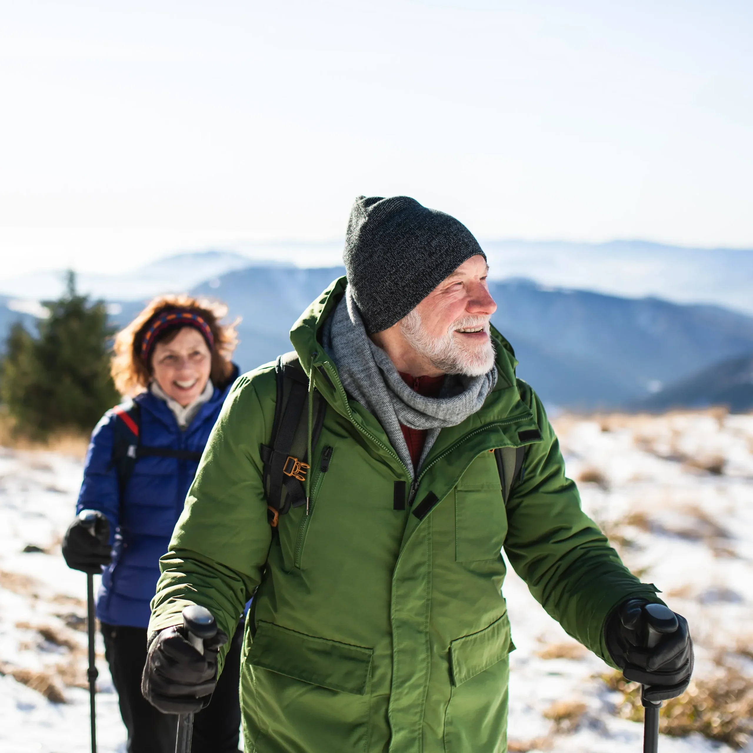 A man and women out in the mountains for a hike.