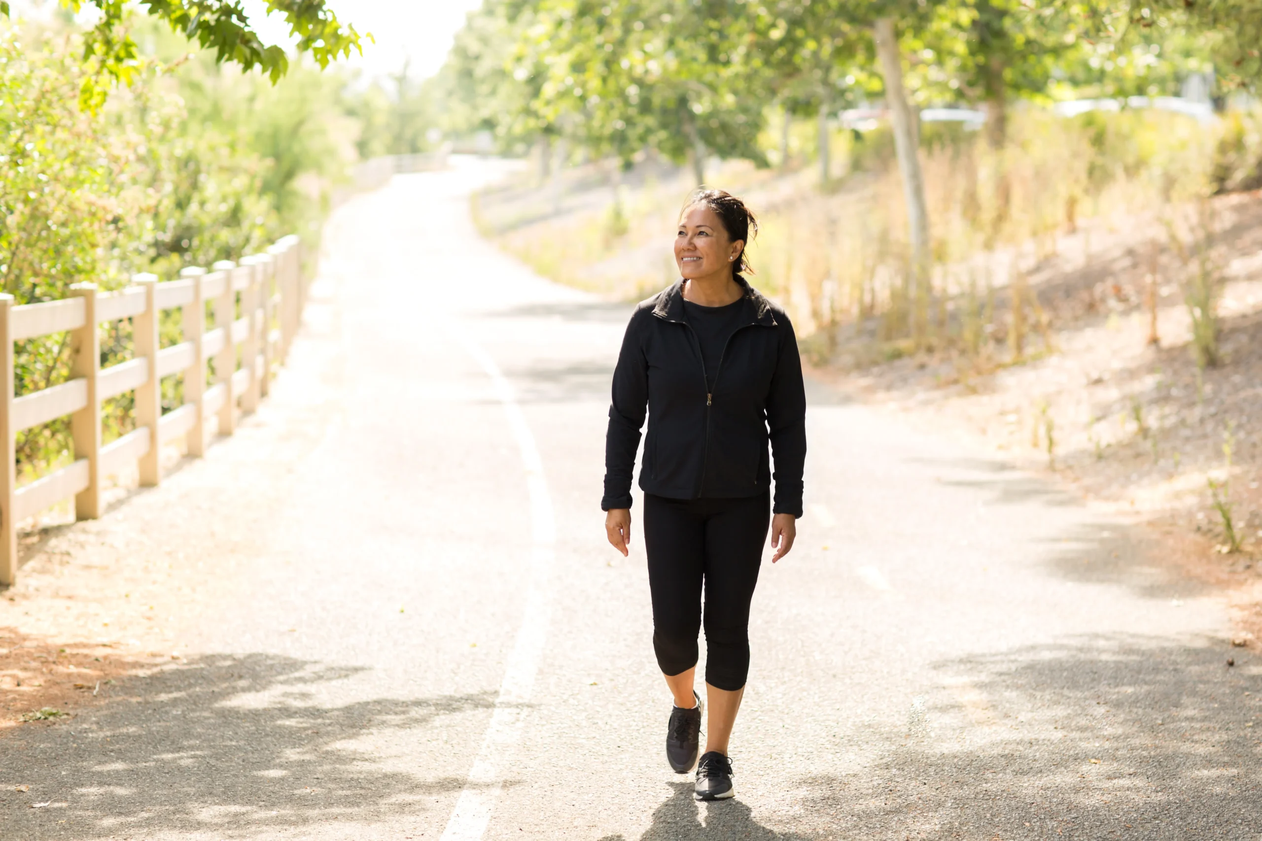 Women walking outside showing that having a walking routine is crucial for staying active.