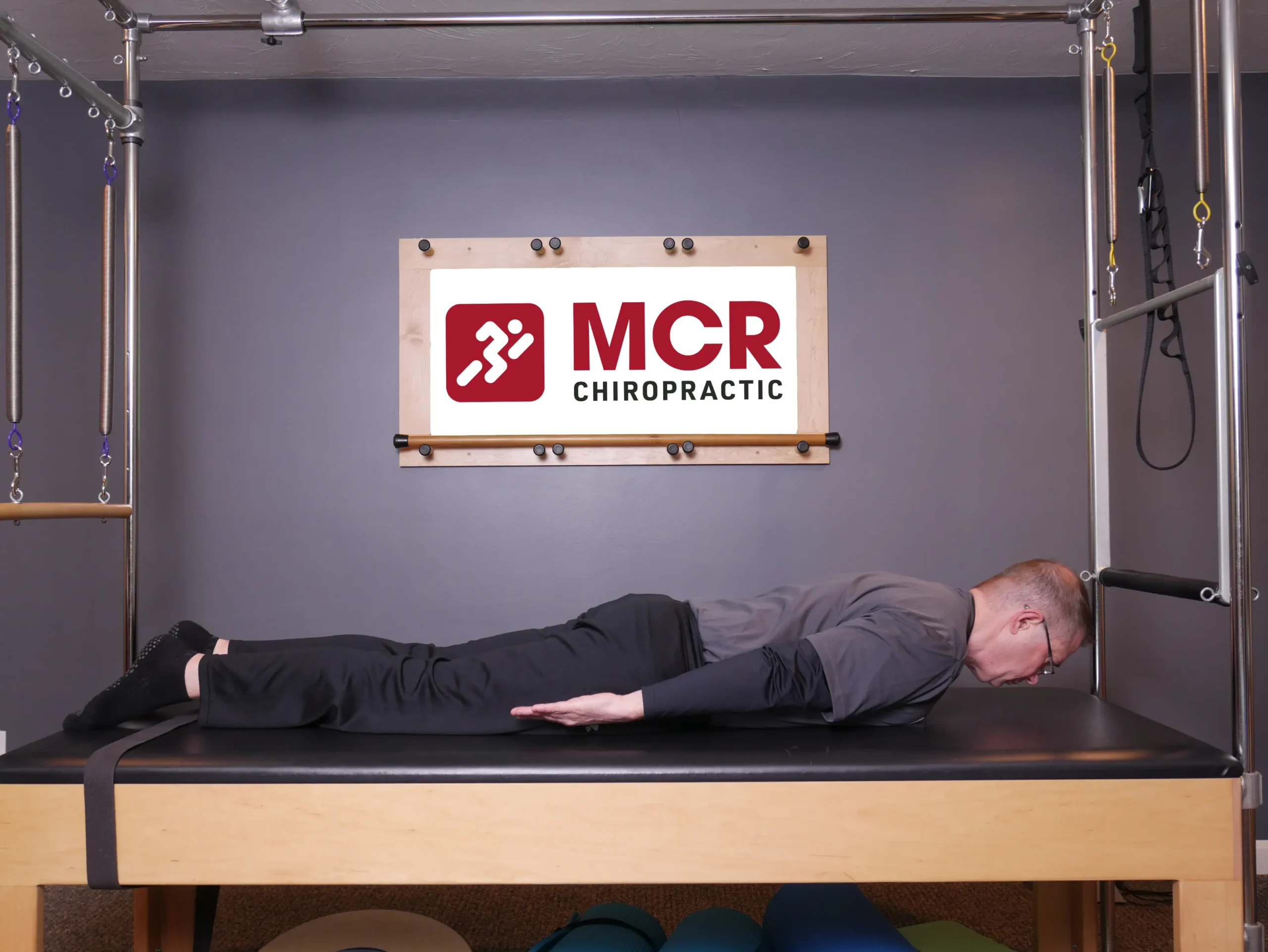 Man laying on the table facedown demonstrating the Darts exercise.