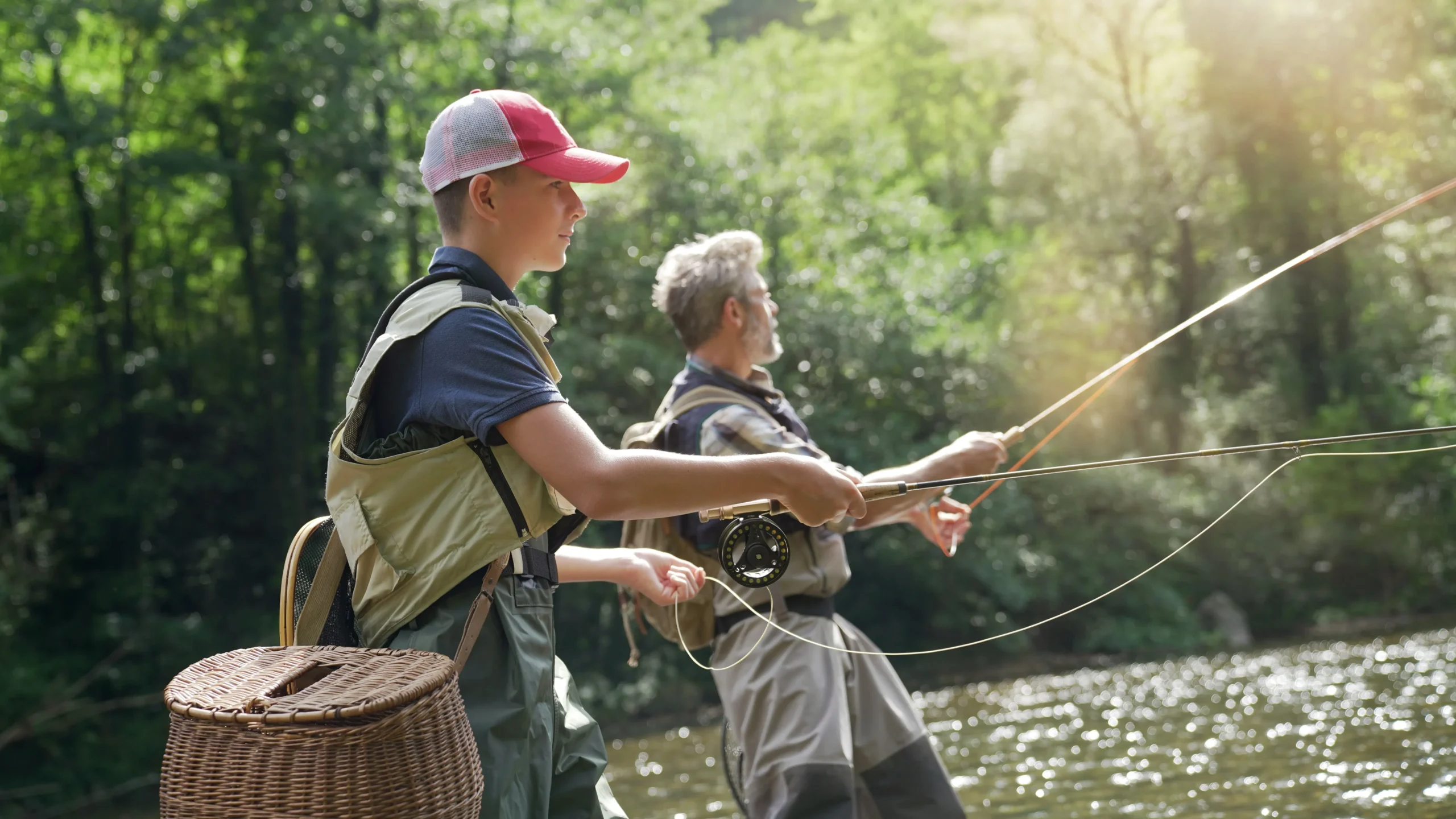 Two men fishing on a lake in the woods emphasizing the benefits of Chiropractic care.